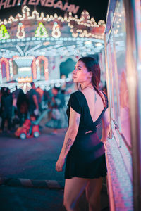 Young woman looking away in city