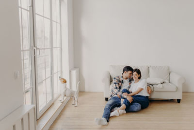 Woman sitting on wooden floor at home