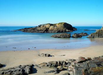 Scenic view of sea against clear blue sky