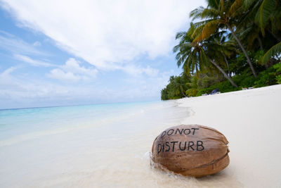 View of text on beach against sky