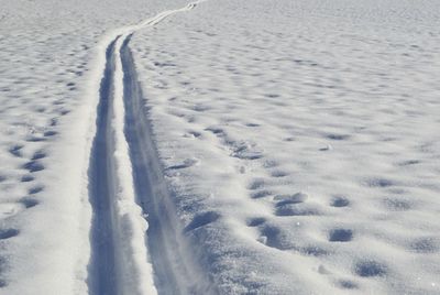 High angle view of footprints on snow covered field