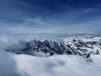 Scenic view of snow covered mountains against sky