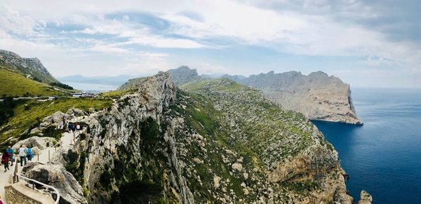 Panoramic view of sea and mountains against sky