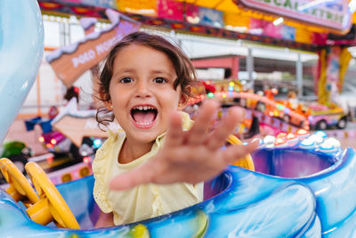 Happy girl looking at camera at the fair smiling