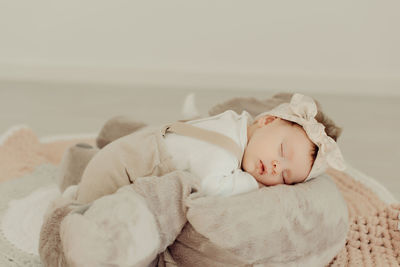 Cute baby girl sleeping on bed at home