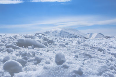 Scenic view of snow covered land against sky