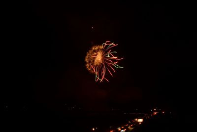 Low angle view of firework display at night