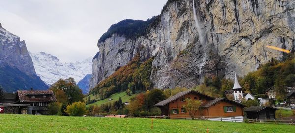 Scenic view of houses and mountains against sky