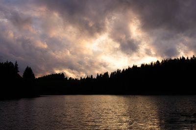 Scenic view of lake against sky at sunset