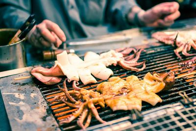 High angle view of squids being gilled on barbeque