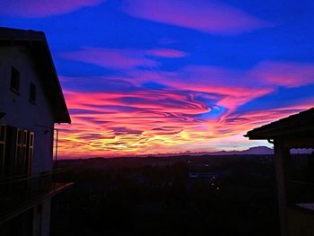 Silhouette built structure against sky at sunset