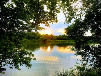 Scenic view of lake against sky at sunset