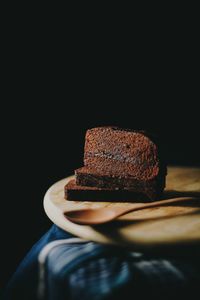 Close-up of cake on table against black background