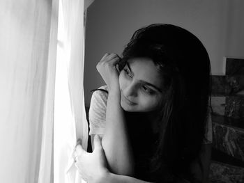 Portrait of a beautiful young woman sitting at home