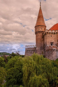 View of tower against cloudy sky