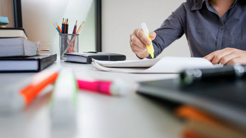 Midsection of woman working on table
