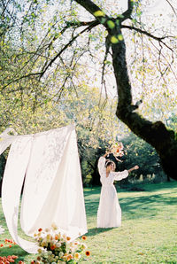 Rear view of bride standing in park