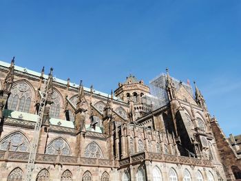 Low angle view of historic building against clear blue sky