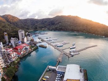 High angle view of harbor by sea against sky