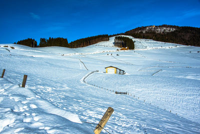 Snow between mountains and valleys with beaten path divided by barbed wire in asiago, vicenza, italy