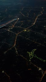 High angle view of illuminated landscape against sky at night