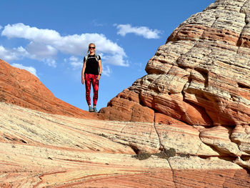 Rear view of man standing on rock formations