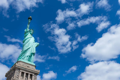 Statue of liberty against cloudy sky