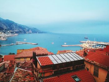 High angle view of city by sea against clear sky