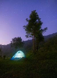 Tent on field against sky at night