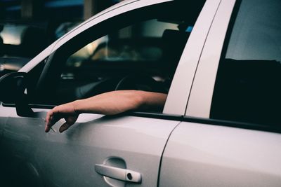 Close-up of hand on car windshield