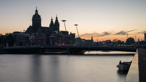 View of bridge over river at sunset