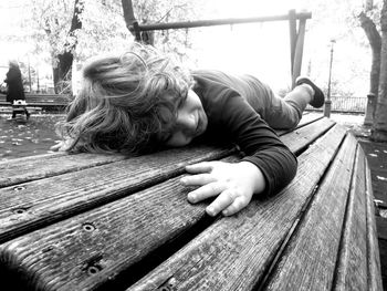 Boy lying down on bench