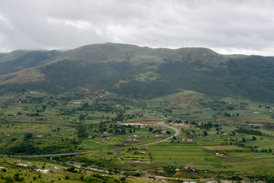 High angle view of green landscape against sky