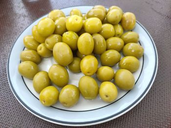 High angle view of fruits in plate on table