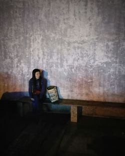 Full length of woman standing on wall