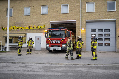 Firefighters in front of fire station