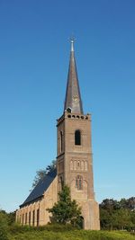 Low angle view of built structure against clear blue sky