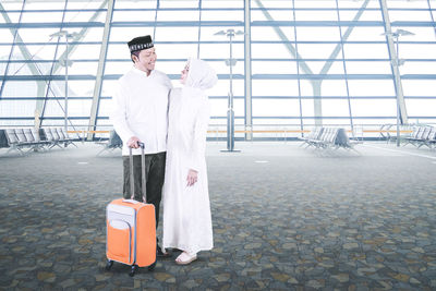 Man holding umbrella standing on tiled floor