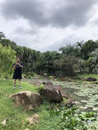 Man standing on field against sky