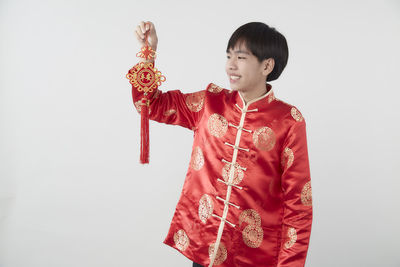 Smiling boy standing against white background