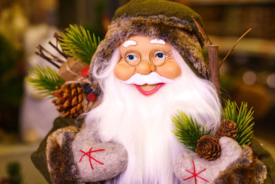 Close-up of santa claus doll, santa claus statue with christmas decorations