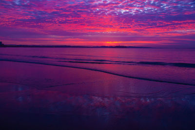 Scenic view of sea against romantic sky at sunset