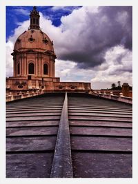 Low angle view of historic building against cloudy sky