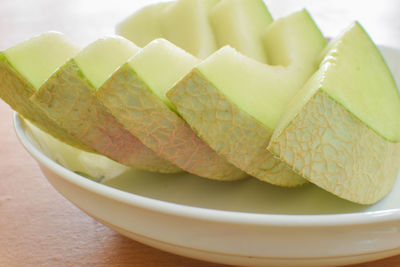 Close-up of melon slices in plate on table