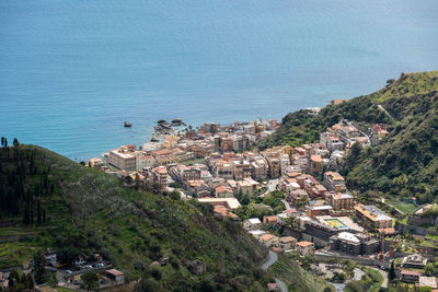 High angle view of townscape by sea against sky