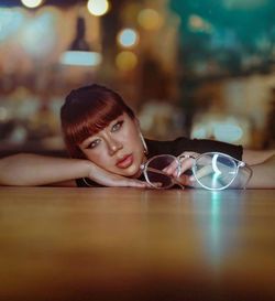 Portrait of teenage girl sitting on table