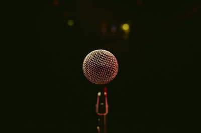 Close-up of lighting equipment against black background