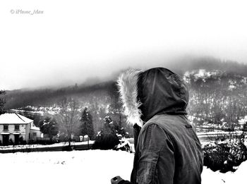 Rear view of man standing in snow