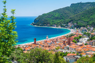 High angle view of townscape by sea against sky