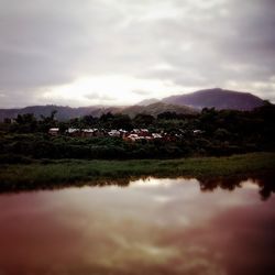 Scenic view of lake against cloudy sky